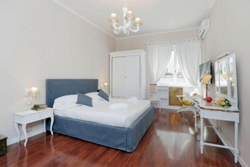 a bedroom with a large bed and a desk at Vatican Art House in Rome