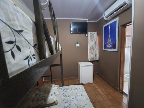 a room with a staircase and a living room at Pousada Pimenta Olimpia in Olímpia