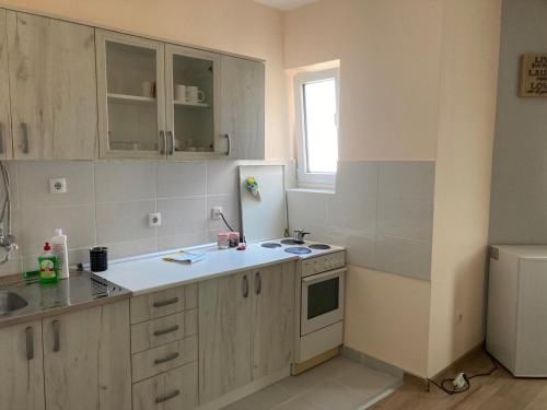 a kitchen with a sink and a refrigerator at STAN NA DAN-LOZNICA 2 in Loznica