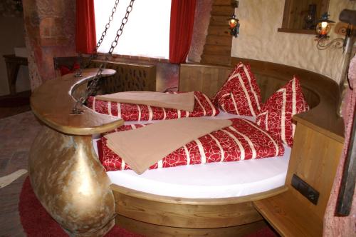 a bedroom with a bed with red pillows at Pension Haus Sanz in Vienna