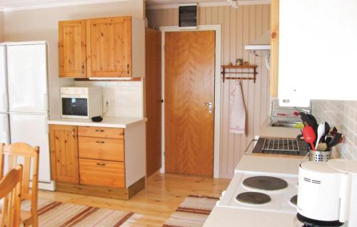 a kitchen with a white refrigerator and a counter top at Awesome Home In Älgarås With Wifi in Hallerud