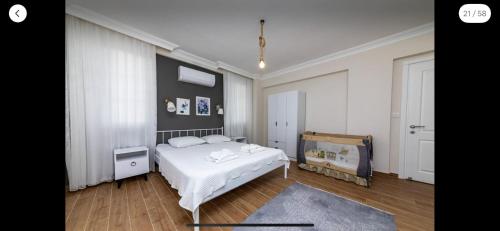 a bedroom with a white bed and a blue rug at Villa Sunset in Dalyan