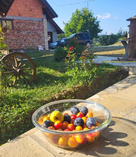 a bowl of fruit sitting on a table at Venera in Kosjerić