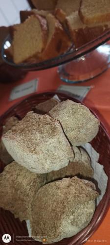 a plate of cookies on a table with a plate of bread at Pousada Refugio do Serrano in São Bento do Sapucaí