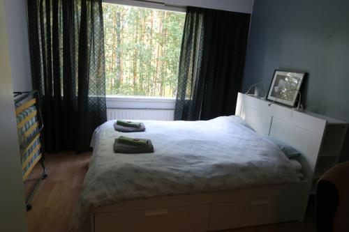 a bedroom with a bed and a large window at 1-Bedroom Apartment with Sauna in Heinola