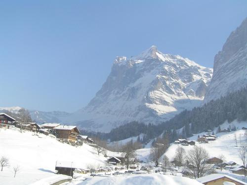 a snow covered mountain in front of a ski resort at Locherboden in Grindelwald