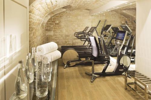 a gym with several exercise bikes in a room at Hotel de Seze in Paris