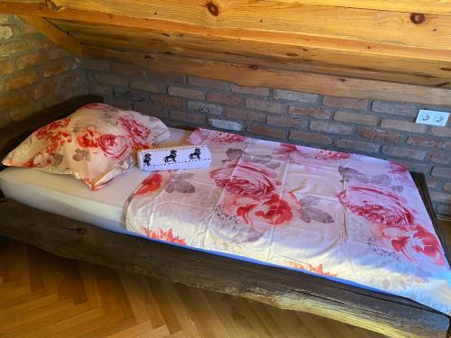 a bed with flowers on it with a sign on it at Matanovi Dvori in Slavonski Brod