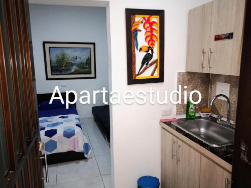 a kitchen with a sink and a counter top at Cómodos y acogedores Apartaestudios - Manizales in Manizales