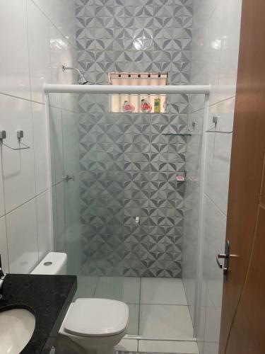 a bathroom with a shower with a toilet and a sink at Casa em barreirinhas in Barreirinhas