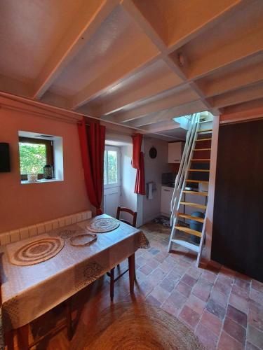 a room with a table and a ladder in it at Four à pain in Torcé-en-Charnie