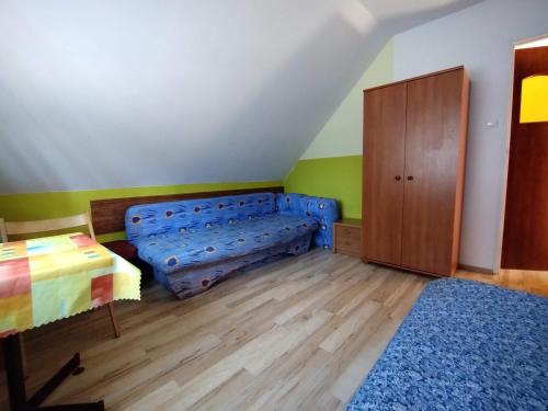 Schlafzimmer mit einem Bett und Holzboden in der Unterkunft Domek całoroczny Pod Sosnami in Pobierowo