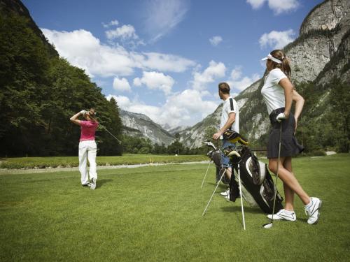 a group of people playing a game of golf at Hotel Gut Brandlhof in Saalfelden am Steinernen Meer