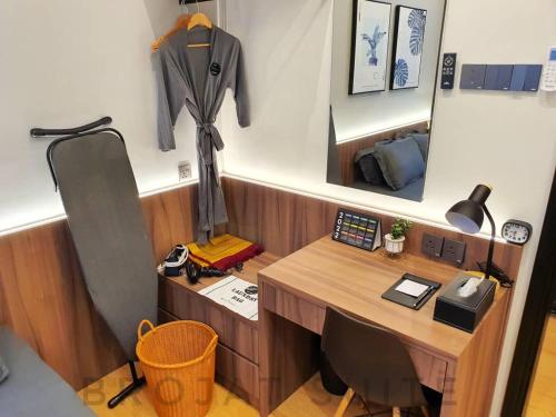 a office with a desk and a coat hanging on a wall at Brojat Suite Family City View @ Imperium Residence in Kuantan