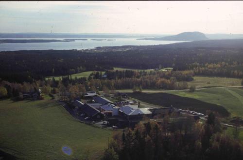 an aerial view of a house on a hill next to a lake at STF Hotel & Hostel Persåsen in Persåsen