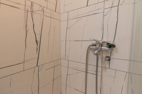 a bathroom with a shower with a hose at Vikendica ''CASA DE TARA'' - Planina Tara in Kaludjerske Bare
