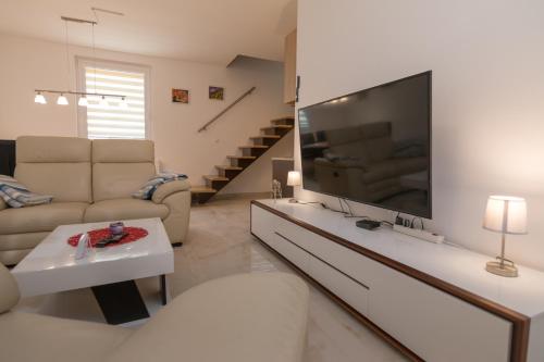 a living room with a large flat screen tv at Vikendica ''CASA DE TARA'' - Planina Tara in Kaludjerske Bare