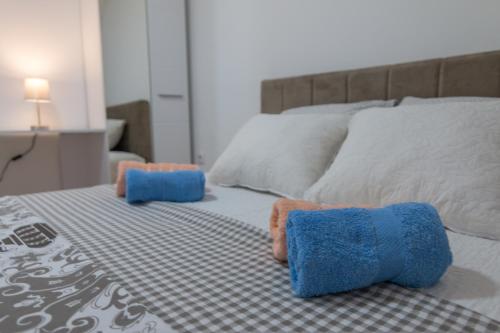 a bed with two stuffed animals on top of it at Vikendica ''CASA DE TARA'' - Planina Tara in Kaludjerske Bare