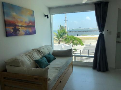 a living room with a couch and a large window at NUEVO Depto vista al mar. in Boca del Río