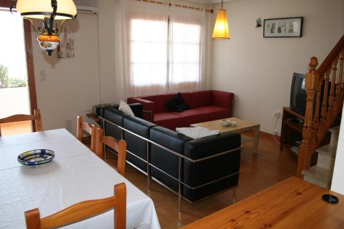 a living room with a couch and a table at Bungalow Mediterraneo in Santa Pola