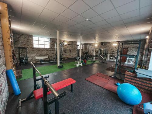 a gym with exercise equipment in a brick building at Near the lake apartment with hot tub and sauna in Tõrva