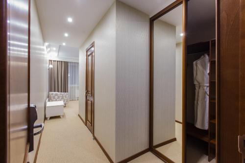 a room with a walk in closet with a mirror at Elegant Hotel in Tomsk