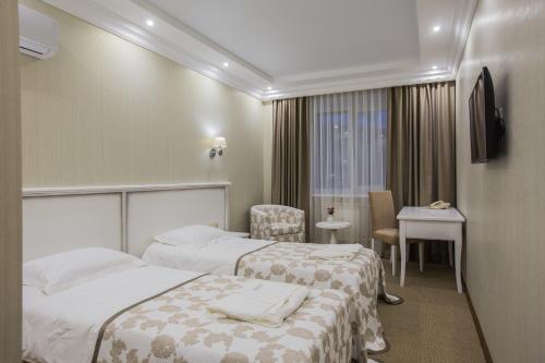 Llit o llits en una habitació de Elegant Hotel
