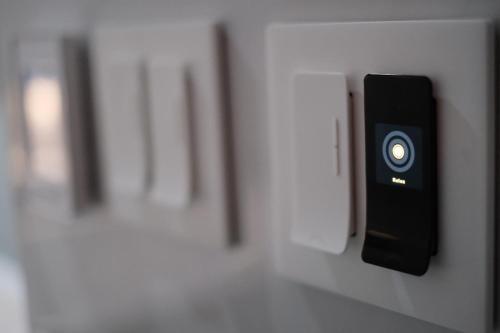 a remote control is hanging on a wall at Stunning exec spa retreat w/panoramic lake views! in Haslett