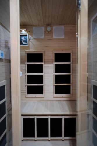 a sauna with three windows in a room at Stunning exec spa retreat w/panoramic lake views! in Haslett
