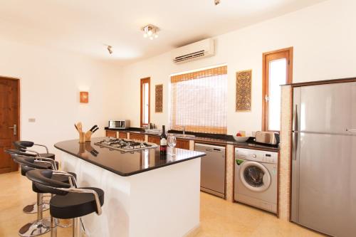 a kitchen with a stove and a refrigerator at Red Rock Apartments in Dahab