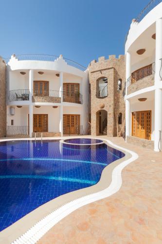 a view of a villa with a swimming pool at Red Rock Apartments in Dahab
