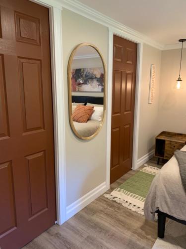 a bedroom with a mirror next to a door at Trinity Guest House in Trinity