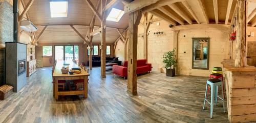 a living room with a red couch and a table at La Ferme De L'âne Rouge 7 nuits minimum in Bernex