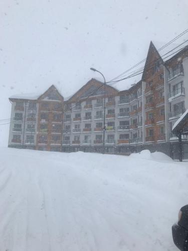 a large apartment building in a snow storm at New Gudauri Twins in Gudauri