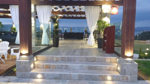 a patio with stairs and a table and chairs at Family Hotel Eterno in Tsigov Chark