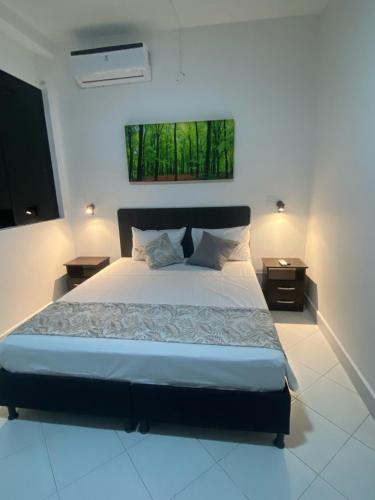 a bedroom with a large bed and two night stands at Campo Godoy in Doradal