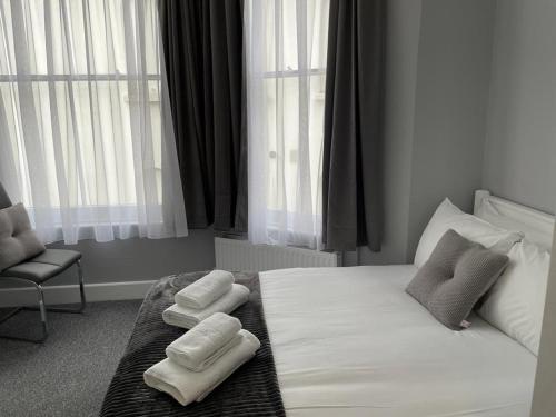 a bedroom with a bed with two towels on it at Ravna Gora in London