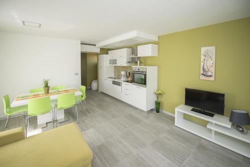 a living room with a kitchen and a dining room at Villa Danex Premium in Umag