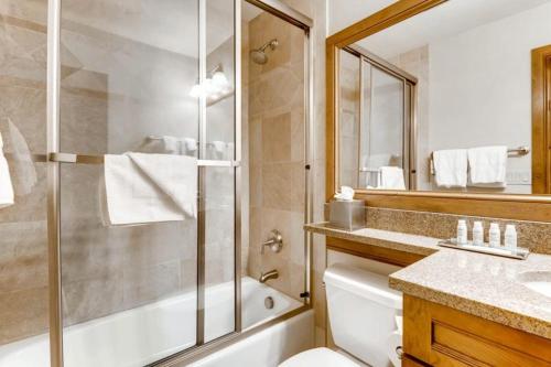 a bathroom with a shower and a toilet and a sink at Luxury Ski In, Ski Out 3 Bedroom Mountain Residence In The Heart Of Lionshead Village With Heated Slope Side Pool And Hot Tub in Vail