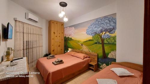 a bedroom with two beds and a painting on the wall at My Zen Apartment (Κεντρικό, ήσυχο, πολλές παροχές) in Preveza