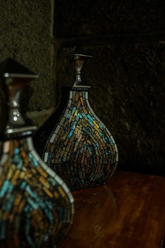 two glass vases sitting on a wooden table at Casa de Campo Gracinda in Tourém