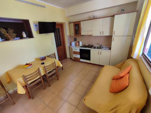 a kitchen and a living room with a table and a couch at Sanmarcomare in Sciacca