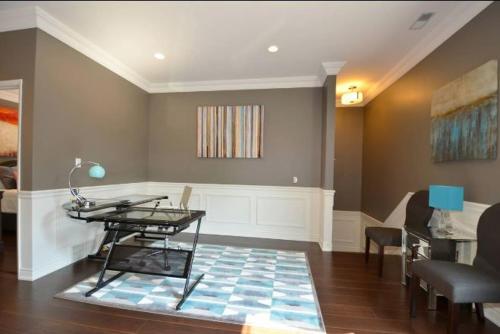 a living room with a table and a couch at The SoMa Furnished Residences in Hamilton