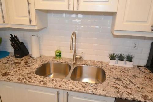 a kitchen counter with a sink in a kitchen at The SoMa Furnished Residences in Hamilton