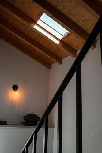 a skylight on a ceiling in a room with a staircase at Casa de Campo Gracinda in Tourém