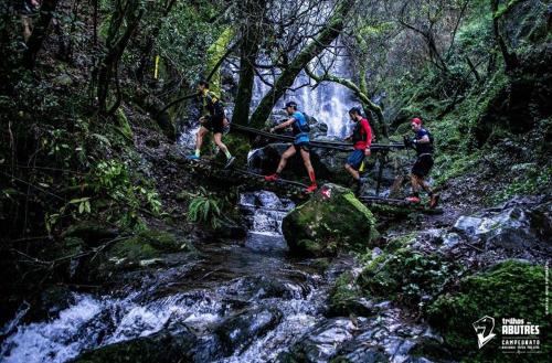 a group of people crossing a bridge over a river at Casa dos Copos - Drinks House in Miranda do Corvo