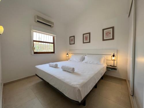 a bedroom with a large bed with two pillows on it at Xookoob Serenity Bungalow in San Bartolomé de Tirajana
