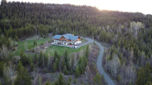 an aerial view of a house in a forest at Little Black Bear Lodge/B&B in Bridge Lake