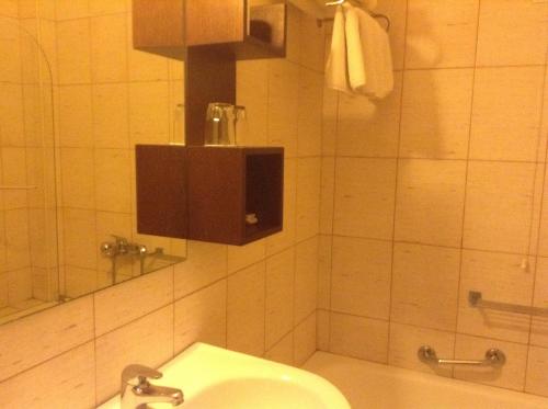 a bathroom with a toilet and a sink and a shower at Hotel Electra in Volos