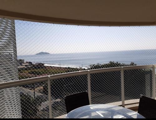 d'un balcon avec une table et une vue sur l'océan. dans l'établissement Espetacular vista do mar - Beto Carrero - Ap502, à Penha